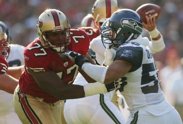 SAN FRANCISCO - NOVEMBER 7:  Offensive tackle Kwame Harris #77 of the San Francisco 49ers tries to hold a block against defensive end Chike Okeafor #50 of the Seattle Seahawks at Monster Park on November 7, 2004 in San Francisco, California. The Seahawks defeated the 49ers 42-27. (Photo by Jed Jacobsohn/Getty Images)