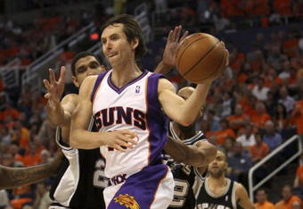 PHOENIX - APRIL 25:  Steve Nash #13 of the Phoenix Suns is defended by Tim Duncan #21 of the San Antonio Spurs during Game Three of the Western Conference Quarterfinals during the 2008 at NBA Playoffs at the at U.S. Airways Center on April 25, 2008.  (Photo by Jed Jacobsohn/Getty Images)