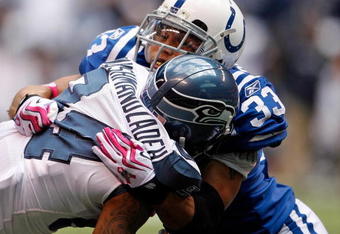 INDIANAPOLIS - OCTOBER 04:  T.J. Houshmandzadeh #84 of the Seattle Seahawks  is tackled by Melvin Bullitt #33 of the Indianapolis Colts during the NFL game against  at Lucas Oil Stadium on October 4, 2009 in Indianapolis, Indiana.  (Photo by Andy Lyons/Getty Images)