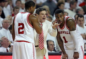 LOUISVILLE, KY - MARCH 01:  Rick Pitino the Head Coach of the Louisville Cardinals gives instructions to Preston Knowles #2 and Terrence Williams #1 during the Big East Conference game against the Marquette Golden Eagles at Freedom Hall on March 1, 2009 in Louisville, Kentucky.  (Photo by Andy Lyons/Getty Images)