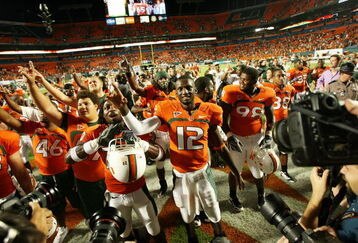 FORT LAUDERDALE, FL - OCTOBER 03: Quarterback Jacory Harris #12 of the Miami Hurricanes celebrates with teammates after a victory over the Oklahoma Sooners at Land Shark Stadium on October 3, 2009 in Fort Lauderdale, Florida. Miami defeated Oklahoma 21-20. (Photo by Doug Benc/Getty Images)