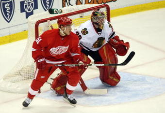 DETROIT - MAY 27:  Valtteri Filppula #51 of the Detroit Red Wings sets up on offense in front of the net against goalie Cristobal Huet #38 of the Chicago Blackhawks during Game Five of the Western Conference Championship Round of the 2009 Stanley Cup Playoffs on May 27, 2009 at Joe Louis Arena in Detroit, Michigan. The Red Wings won 2-1 in overtime. (Photo by Claus Andersen/Getty Images)