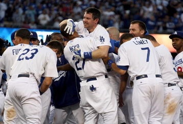 LOS ANGELES, CA - OCTOBER 08:  (M) Mark Loretta #5 is picked up by Matt Kemp #27 of the Los Angeles Dodgers as they celebrate after Loretta hit a walk-off RBI to defeat the St. Louis Cardinals in Game Two of the NLDS during the 2009 MLB Playoffs at Dodger Stadium on October 8, 2009 in Los Angeles, California. The Dodgers defeated the Cardinals 3-2 to take a 2-0 series lead.  (Photo by Stephen Dunn/Getty Images)