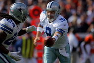 DENVER - OCTOBER 04: Quarterback Tony Romo #9 of the Dallas Cowboys hands off to running back Marion Barber #24 against the Denver Broncos during NFL action at Invesco Field at Mile High on October 4, 2009 in Denver, Colorado. The Broncos defeated the Cowboys 17-10. (Photo by Doug Pensinger/Getty Images)