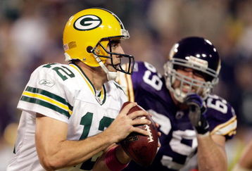 MINNEAPOLIS - OCTOBER 05:  Quarterback Aaron Rodgers #12 of the Green Bay Packers is chased by Jared Allen #69 of the Minnesota Vikings during the Monday Night Football game on October 5, 2009 at Hubert H. Humphrey Metrodome in Minneapolis, Minnesota.  (Photo by Jamie Squire/Getty Images)