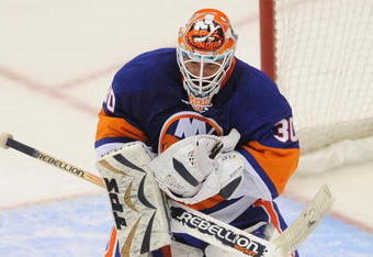 UNIONDALE, NY - OCTOBER 03: Goaltender Dwayne Roloson #30  makes a save against the Pittsburgh Penguins during the NHL hockey game at Nassau Coliseum on October 3, 2009 in Uniondale, New York. The Penguins defeated the Islanders 4-3 in shootout overtime.  (Photo by Paul Bereswill/Getty Images)