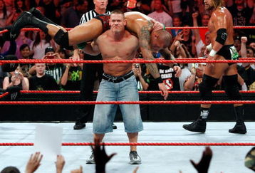 LAS VEGAS - AUGUST 24:  Wrestler John Cena picks up wrestler Randy Orton as wrestler Triple H (R) looks on during the WWE Monday Night Raw show at the Thomas & Mack Center August 24, 2009 in Las Vegas, Nevada.  (Photo by Ethan Miller/Getty Images)