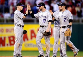 PHILADELPHIA - OCTOBER 08:  (L-R) Clint Barmes #12, Todd Helton #17, Ian Stewart #8 and Troy Tulowitzki #2 of the Colorado Rockies celebrate their 5-4 win against the Philadelphia Phillies in Game Two of the NLDS during the 2009 MLB Playoffs at Citizens Bank Park on October 8, 2009 in Philadelphia, Pennsylvania.  (Photo by Jeff Zelevansky/Getty Images)