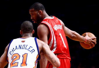 NEW YORK - JANUARY 26: Tracy McGrady #1 of the Houston Rockets looks for options under pressure from Wilson Chandler #21 of the New York Knicks at Madison Square Garden January 26, 2009 in New York City. NOTE TO USER: User expressly acknowledges and agrees that, by downloading and/or using this Photograph, User is consenting to the terms and conditions of the Getty Images License Agreement.  (Photo by Chris McGrath/Getty Images)