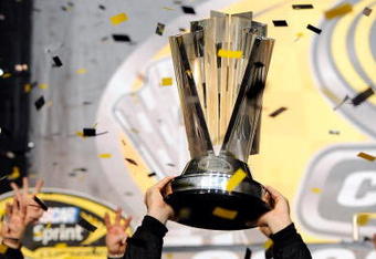 HOMESTEAD, FL - NOVEMBER 16:  Jimmie Johnson (R), driver of the #48 Lowe's/Kobalt Tools Chevrolet, holds up the trophy after winning the 2008 NASCAR Sprint Cup Series Championship after the Ford 400 at Homestead-Miami Speedway on November 16, 2008 in Homestead, Florida.  (Photo by Rusty Jarrett/Getty Images for NASCAR)