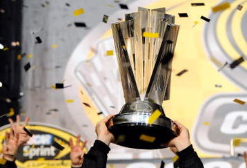 HOMESTEAD, FL - NOVEMBER 16:  Jimmie Johnson (R), driver of the #48 Lowe's/Kobalt Tools Chevrolet, holds up the trophy after winning the 2008 NASCAR Sprint Cup Series Championship after the Ford 400 at Homestead-Miami Speedway on November 16, 2008 in Homestead, Florida.  (Photo by Rusty Jarrett/Getty Images for NASCAR)
