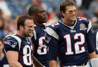 FOXBORO, MA - OCTOBER 4:  (L-R) Wes Welker #83, Benjamin Watson #84, and Tom Brady #12 of the New England Patriots, stand on the sideline before a game with the Baltimore Ravens at Gillette Stadium on October 4, 2009 in Foxboro, Massachusetts. (Photo by Jim Rogash/Getty Images)