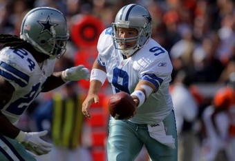 DENVER - OCTOBER 04:  Quarterback Tony Romo #9 of the Dallas Cowboys hands off to running back Marion Barber #24 against the Denver Broncos during NFL action at Invesco Field at Mile High on October 4, 2009 in Denver, Colorado. The Broncos defeated the Cowboys 17-10.  (Photo by Doug Pensinger/Getty Images)