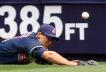 NEW YORK - APRIL 19:  Grady Sizemore #24 of the Cleveland Indians dives for a ball hit by Derek Jeter #2 of the New York Yankees at Yankee Stadium on April 19, 2009 in the Bronx borough of New York City.  (Photo by Ezra Shaw/Getty Images)