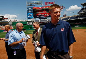 WASHINGTON - AUGUST 21:  Stephen Strasburg (R), the overall first pick in the 2009 Major League Baseball draft, arrives for a press conference where he was introduced at Nationals Park August 21, 2009 in Washington, DC. Strasburg, a right handed pitcher from San Diego State University, signed with the Nationals earlier this week wth a record contract for an amateur player. Also pictured (L-R) are Nationals Team President Stan Kasten, Nationals GM Mike Rizzo and Strasburg's agent Scott Boras.  (Photo by Win McNamee/Getty Images)