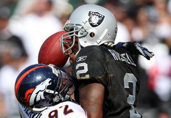 OAKLAND, CA - SEPTEMBER 27:  JaMarcus Russell #2 of the Oakland Raiders is sacked by Elvis Dumervil #92 of the Denver Broncos on September 27, 2009 during an NFL game at the Oakland-Alameda County Coliseum in Oakland, California.  (Photo by Jed Jacobsohn/Getty Images)