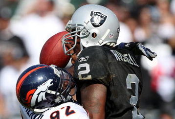 OAKLAND, CA - SEPTEMBER 27:  JaMarcus Russell #2 of the Oakland Raiders is sacked by Elvis Dumervil #92 of the Denver Broncos on September 27, 2009 during an NFL game at the Oakland-Alameda County Coliseum in Oakland, California.  (Photo by Jed Jacobsohn/Getty Images)