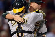 BOSTON - JULY 06:  Starting pitcher Brett Anderson #49 of the Oakland Athletics is congratulated by Kurt Suzuki #8 after his shutout against the Boston Red Sox on July 6, 2009 at Fenway Park in Boston, Massachusetts. The Athletics defeated the Red Sox 6-0.  (Photo by Elsa/Getty Images)
