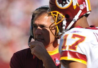 LANDOVER, MD - OCTOBER 4:  Head coach Jim Zorn speaks with Jason Campbell #17 of the Washington Redskins during a time out against the Tampa Bay Buccaneers at FedExField on October 4, 2009 in Landover, Maryland. The Redskins defeated the Buccaneers 16-13. (Photo by Larry French/Getty Images)