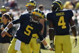 ANN ARBOR, MI - SEPTEMBER 19:  Quarterback Tate Forcier #5 of the Michigan Wolverines greets running back Brandon Minor #4 during warmups for the game against the Eastern Michigan Eagles at Michigan Stadium on September 19, 2009 in Ann Arbor, Michigan.  Michigan won 45-17.  (Photo by Stephen Dunn/Getty Images)
