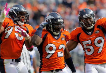 DENVER - OCTOBER 04:  Elivs Dumervil #92 of the Denver Broncos celebrates his sack of quarterback Tony Romo #9 of the Dallas Cowboys with teammates Darrell Reid #95 and Wesley Woodyard #59 during NFL action at Invesco Field at Mile High on October 4, 2009 in Denver, Colorado. The Broncos defeated the Cowboys 17-10.  (Photo by Doug Pensinger/Getty Images)