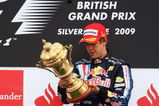 NORTHAMPTON, UNITED KINGDOM - JUNE 21:  Sebastian Vettel of Germany and Red Bull Racing celebrates on the podium after winning the British Formula One Grand Prix at Silverstone on June 21, 2009 in Northampton, England.  (Photo by Paul Gilham/Getty Images)