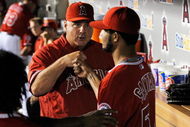 ANAHEIM, CA - SEPTEMBER 28: Winning pitcher Ervin Santana #54 of the Los Angeles Angels of Anaheim is congratulated by manager Mike Scioscia during the eight inning against Texas Rangers before the Angels won the American League West title at Angel Stadium on September 28, 2009 in Anaheim, California. (Photo by Kevork Djansezian/Getty Images)