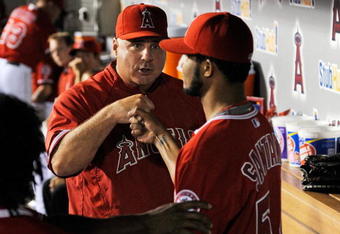 ANAHEIM, CA - SEPTEMBER 28:  Winning pitcher Ervin Santana #54 of the Los Angeles Angels of Anaheim is congratulated by manager Mike Scioscia during the eight inning against Texas Rangers before the Angels  won the American League West title  at Angel Stadium on September 28, 2009 in Anaheim, California.  (Photo by Kevork Djansezian/Getty Images)