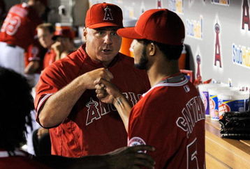 ANAHEIM, CA - SEPTEMBER 28:  Winning pitcher Ervin Santana #54 of the Los Angeles Angels of Anaheim is congratulated by manager Mike Scioscia during the eight inning against Texas Rangers before the Angels  won the American League West title  at Angel Stadium on September 28, 2009 in Anaheim, California.  (Photo by Kevork Djansezian/Getty Images)