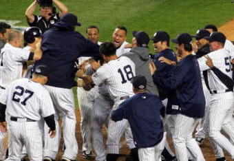 NEW YORK - OCTOBER 09:  The New York Yankees celebrate a walk off home run in the eleventh inning by Mark Teixeira #25 against the Minnesota Twins in Game Two of the ALDS during the 2009 MLB Playoffs at Yankee Stadium on October 9, 2009 in the Bronx borough of New York City.  (Photo by Jared Wickerham/Getty Images)