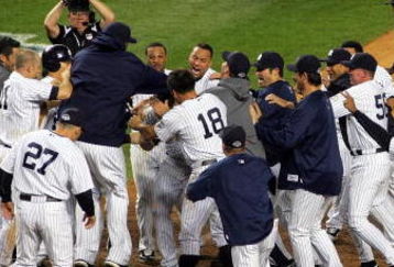 NEW YORK - OCTOBER 09:  The New York Yankees celebrate a walk off home run in the eleventh inning by Mark Teixeira #25 against the Minnesota Twins in Game Two of the ALDS during the 2009 MLB Playoffs at Yankee Stadium on October 9, 2009 in the Bronx borough of New York City.  (Photo by Jared Wickerham/Getty Images)