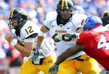 LAWRENCE, KS - SEPTEMBER 26:  Quarterback Austin Davis #12 of the Southern Mississippi Golden Eagles scrambles as Micah Brown #69 throws a block during the game against the Kansas Jayhawks on September 26, 2009 at Memorial Stadium in Lawrence, Kansas.  (Photo by Jamie Squire/Getty Images)