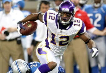 DETROIT - SEPTEMBER 20:  Wide receiver Percy Harvin #12 of the Minnesota Vikings carries the ball past safety Louis Delmas #26 of the Detroit Lions at Ford Field on September 20, 2009 in Detroit, Michigan. The Vikings won 27-13.  (Photo by Stephen Dunn/Getty Images)