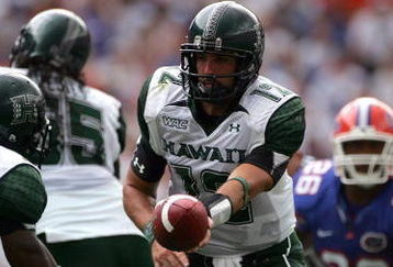 GAINESVILLE, FL - AUGUST 30:  Quarterback Greg Alexander #12 of the Hawaii Warriors hands off the ball during a game against the Florida Gators at Ben Hill Griffin Stadium on August 30, 2008 in Gainesville, Florida.  (Photo by Sam Greenwood/Getty Images)