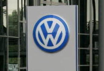 WOLFSBURG, GERMANY - JUNE 27: People holding umbrellas stand in front of a Volkswagen sign during the VFL Wolfsburg training session on June 27, 2007 in Wolfsburg, Germany.  (Photo by Martin Rose/Getty Images)