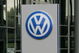 WOLFSBURG, GERMANY - JUNE 27: People holding umbrellas stand in front of a Volkswagen sign during the VFL Wolfsburg training session on June 27, 2007 in Wolfsburg, Germany.  (Photo by Martin Rose/Getty Images)