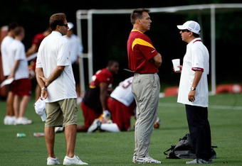ASHBURN, VA - JULY 30:  Washington Redskins Head Coach Jim Zorn (C) talks with owner Daniel Snyder (R) as Executive Vice President for Football Operations Vinny Cerrato (L) looks on during the first day of training camp July 30, 2009 in Ashburn, Virginia.  (Photo by Win McNamee/Getty Images)