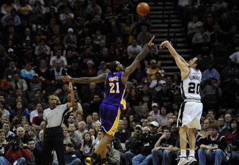SAN ANTONIO - JANUARY 14:  Manu Ginobili #20 of the San Antonio Spurs takes a shot against Josh Powell #21 of the Los Angeles Lakers on January 14, 2009 at AT&T Center in San Antonio, Texas.  NOTE TO USER: User expressly acknowledges and agrees that, by downloading and/or using this Photograph, user is consenting to the terms and conditions of the Getty Images License Agreement.  (Photo by Ronald Martinez/Getty Images)