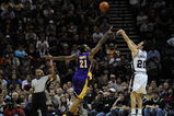 SAN ANTONIO - JANUARY 14:  Manu Ginobili #20 of the San Antonio Spurs takes a shot against Josh Powell #21 of the Los Angeles Lakers on January 14, 2009 at AT&T Center in San Antonio, Texas.  NOTE TO USER: User expressly acknowledges and agrees that, by downloading and/or using this Photograph, user is consenting to the terms and conditions of the Getty Images License Agreement.  (Photo by Ronald Martinez/Getty Images)