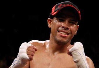 LAS VEGAS - DECEMBER 06:  (L-R) Juan Manuel Lopez of Puerto Rico celebrates his first round knockout of Sergio Medina of Argentina during their WBO junior featherweight title fight at the MGM Grand Garden Arena December 6, 2008 in Las Vegas, Nevada.  (Photo by Jed Jacobsohn/Getty Images)
