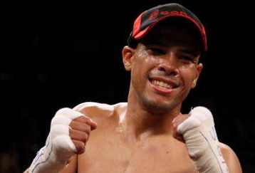LAS VEGAS - DECEMBER 06:  (L-R) Juan Manuel Lopez of Puerto Rico celebrates his first round knockout of Sergio Medina of Argentina during their WBO junior featherweight title fight at the MGM Grand Garden Arena December 6, 2008 in Las Vegas, Nevada.  (Photo by Jed Jacobsohn/Getty Images)