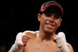 LAS VEGAS - DECEMBER 06:  (L-R) Juan Manuel Lopez of Puerto Rico celebrates his first round knockout of Sergio Medina of Argentina during their WBO junior featherweight title fight at the MGM Grand Garden Arena December 6, 2008 in Las Vegas, Nevada.  (Photo by Jed Jacobsohn/Getty Images)