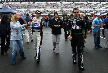 LONG POND, PA - AUGUST 02: Jimmie Johnson (L), driver of the #48 Lowe's Chevrolet and Carl Edwards (R), driver of the #99 Aflac Ford, walk through the garage area prior to the NASCAR Sprint Cup Series Sunoco Red Cross Pennsylvania 500 at the Pocono Raceway on August 2, 2009 in Long Pond, Pennsylvania. The Pennsylvania 500 was postponed until Monday, August 3, 2009 due to rain showers. (Photo by Chris McGrath/Getty Images)