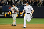 NEW YORK - OCTOBER 09:  Mark Teixeira #25 of the New York Yankees celebrates as he runs past Nick Punto #8 after hitting a walk off home run in the eleventh inning against the Minnesota Twins in Game Two of the ALDS during the 2009 MLB Playoffs at Yankee Stadium on October 9, 2009 in the Bronx borough of New York City.  (Photo by Jim McIsaac/Getty Images)