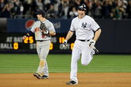 NEW YORK - OCTOBER 09:  Mark Teixeira #25 of the New York Yankees celebrates as he runs past Nick Punto #8 after hitting a walk off home run in the eleventh inning against the Minnesota Twins in Game Two of the ALDS during the 2009 MLB Playoffs at Yankee Stadium on October 9, 2009 in the Bronx borough of New York City.  (Photo by Jim McIsaac/Getty Images)