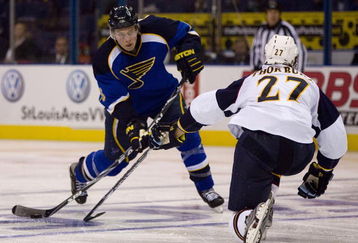 ST. LOUIS, MO - OCTOBER 8: Eric Johnson #6 of the St. Louis Blues shoots the puck against the Atlanta Thrashers  at the Scottrade Center on October 8, 2009 in St. Louis, Missouri.  (Photo by Dilip Vishwanat/Getty Images)