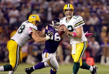 MINNEAPOLIS - OCTOBER 05:  Quarterback Aaron Rodgers #12 of the Green Bay Packers is chased by Brian Robinson #96 of the Minnesota Vikings during the Monday Night Football game on October 5, 2009 at Hubert H. Humphrey Metrodome in Minneapolis, Minnesota.  (Photo by Jamie Squire/Getty Images)