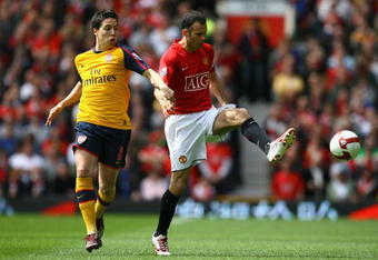 MANCHESTER, UNITED KINGDOM - MAY 16:  Samir Nasri of Arsenal competes for the ball with Ryan Giggs of Manchester United during the Barclays Premier League match between Manchester United and Arsenal at Old Trafford on May 16, 2009 in Manchester, England. (Photo by Alex Livesey/Getty Images)