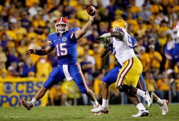 BATON ROUGE, LA - OCTOBER 10:  Quarterback Tim Tebow #15 of the Florida Gators scrambles as he throws a pass against the Louisiana State University Tigers at Tiger Stadium on October 10, 2009 in Baton Rouge, Louisiana.  (Photo by Kevin C. Cox/Getty Images)