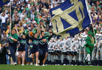 SOUTH BEND, IN - OCTOBER 03: Cheerleaders and the leprechaun mascot of the Notre Dame Fighting Irish run onto the field before a game against the Washington Huskies on October 3, 2009 at Notre Dame Stadium in South Bend, Indiana. Notre Dame defeated Washington 37-30in overtime. (Photo by Jonathan Daniel/Getty Images)